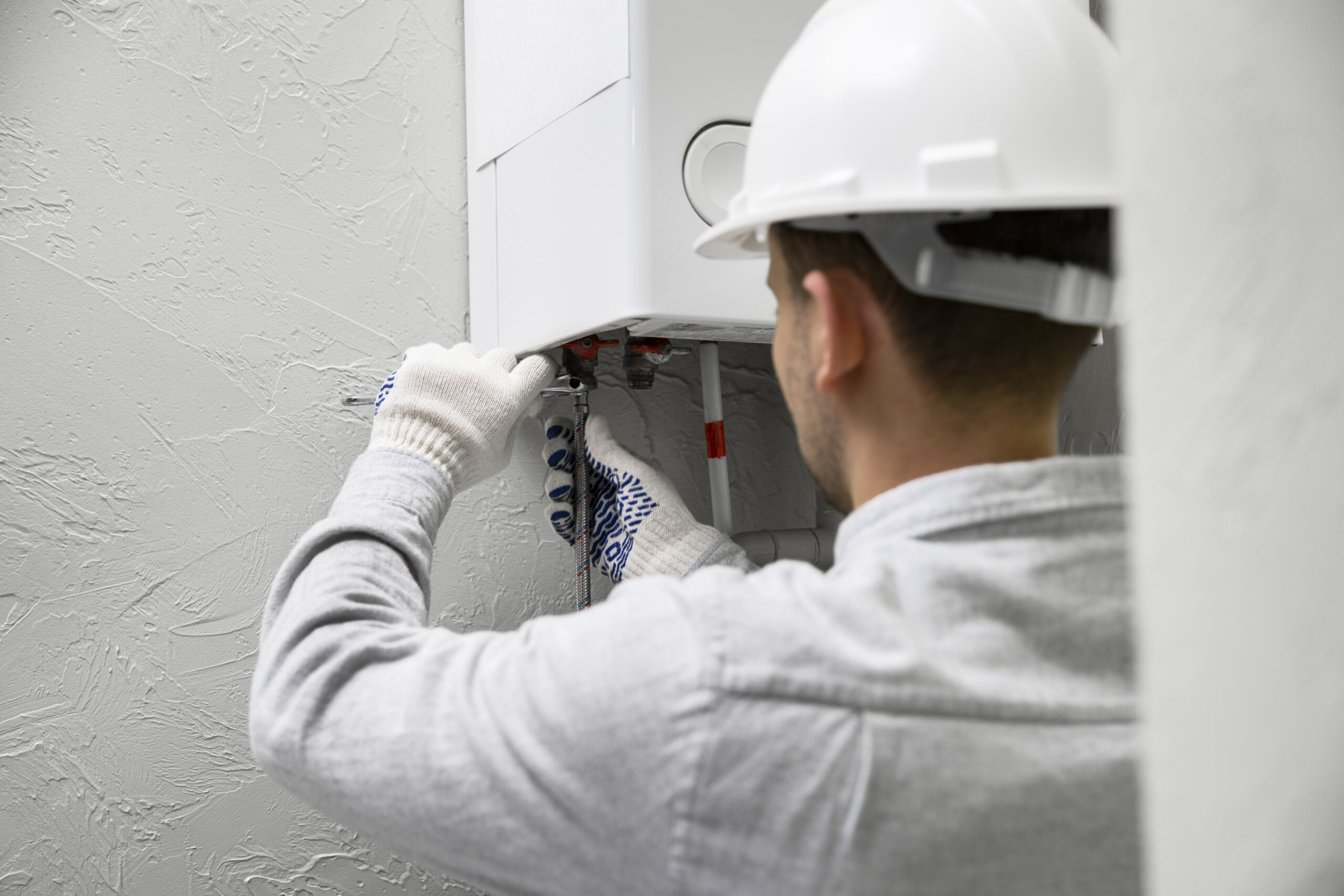 A plumber installing a new boiler